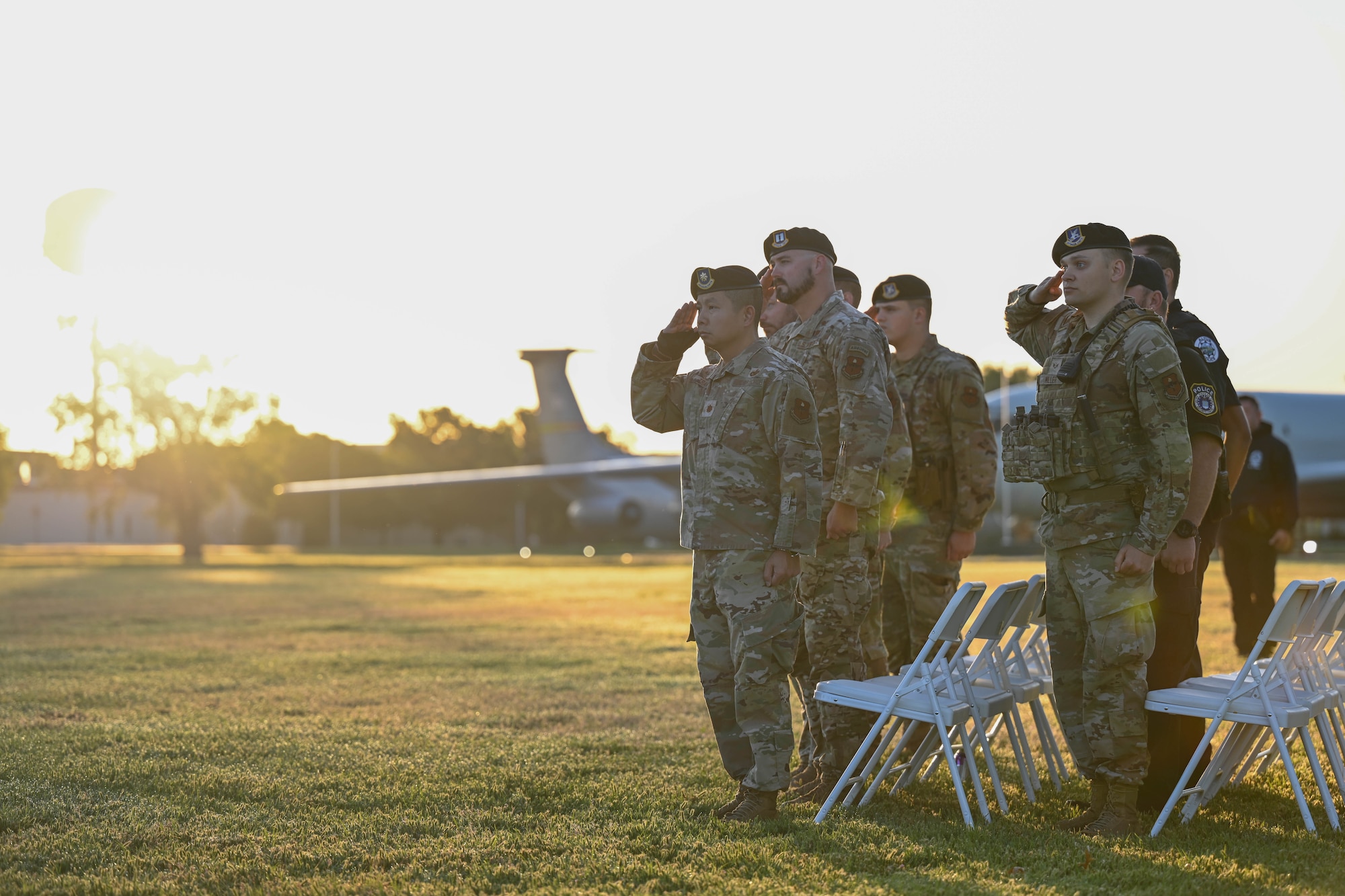 Airmen from the 97th Security Forces Squadron salute the U.S. flag during the playing of reveille at Altus Air Force Base, Oklahoma, May 11, 2025. The opening ceremony marked the beginning of a week focused on remembrance, resilience, and readiness. (U.S. Air Force photo by Airman 1stClass Lauren Torres)