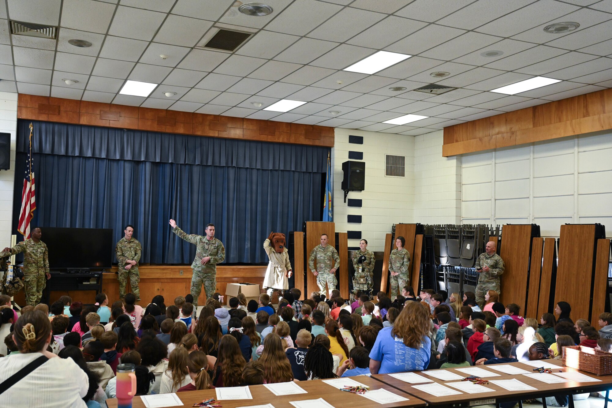 Airmen from the 97th Security Forces Squadron (SFS) brief students of L. Mendel Rivers Elementary School at Altus Air Force Base, Oklahoma, May 11, 2025. The 97th SFS demonstrated how to properly put on military gear and provided coloring sheets for children to create letters for deployed Airmen. (U.S. Air Force photo by Airman 1st Class Lauren Torres)