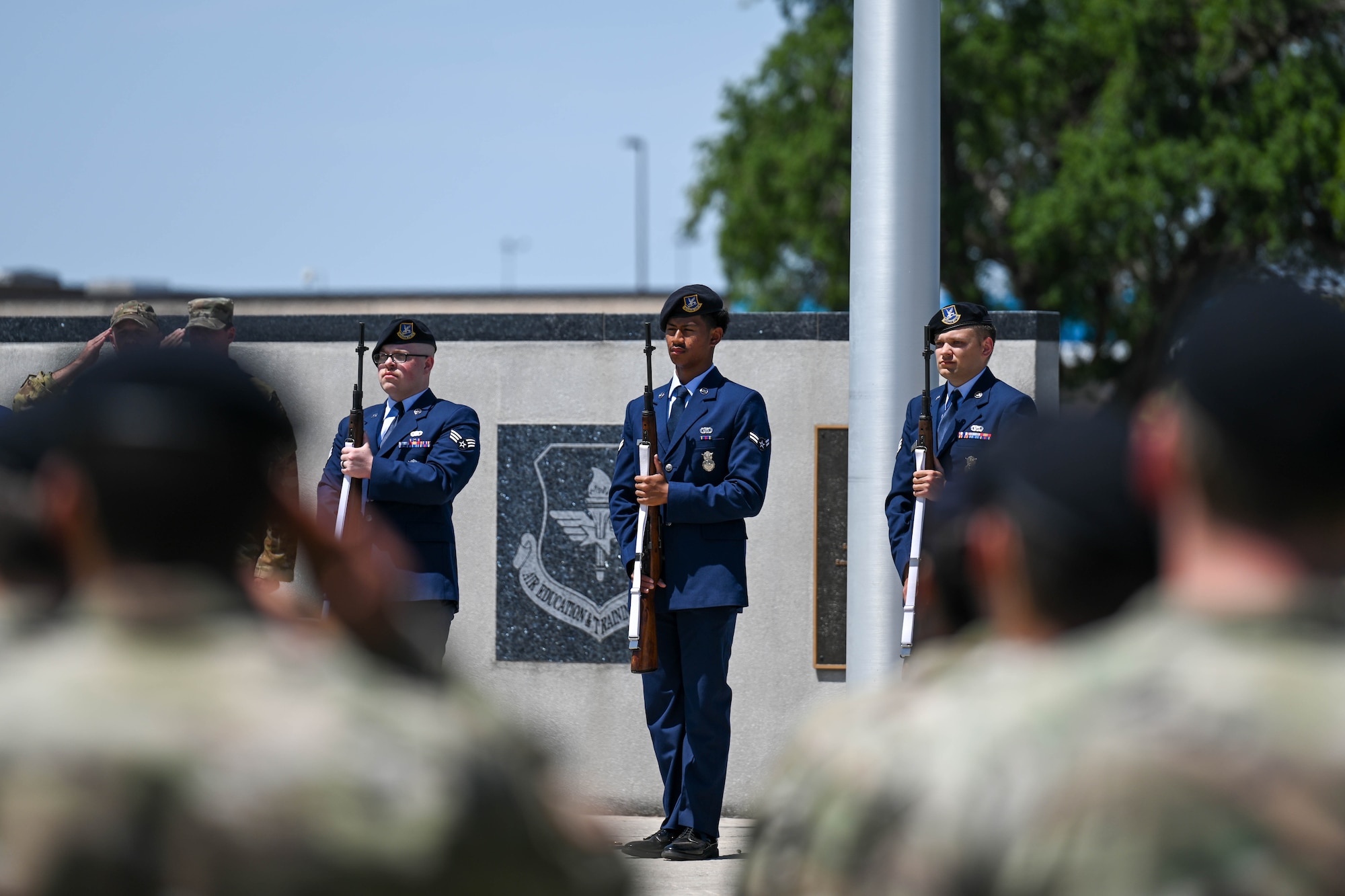 Airmen from the 97th Security Forces Squadron perform a military gun salute at Altus Air Force Base, Oklahoma, May 16, 2025. The gun salute was performed during the closing ceremony of 2025National Police Week to honor the fallen. (U.S. Air Force photo by Airman 1st Class Lauren Torres)