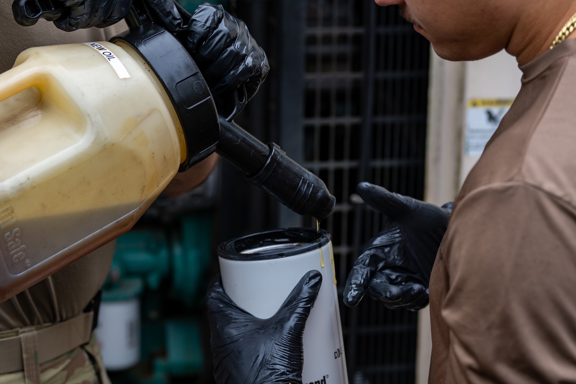 A U.S. Air Force civil engineer assigned to the 1st Special Operations Wing pours oil into a filter at Hurlburt Field, Florida, Jan. 13, 2025.