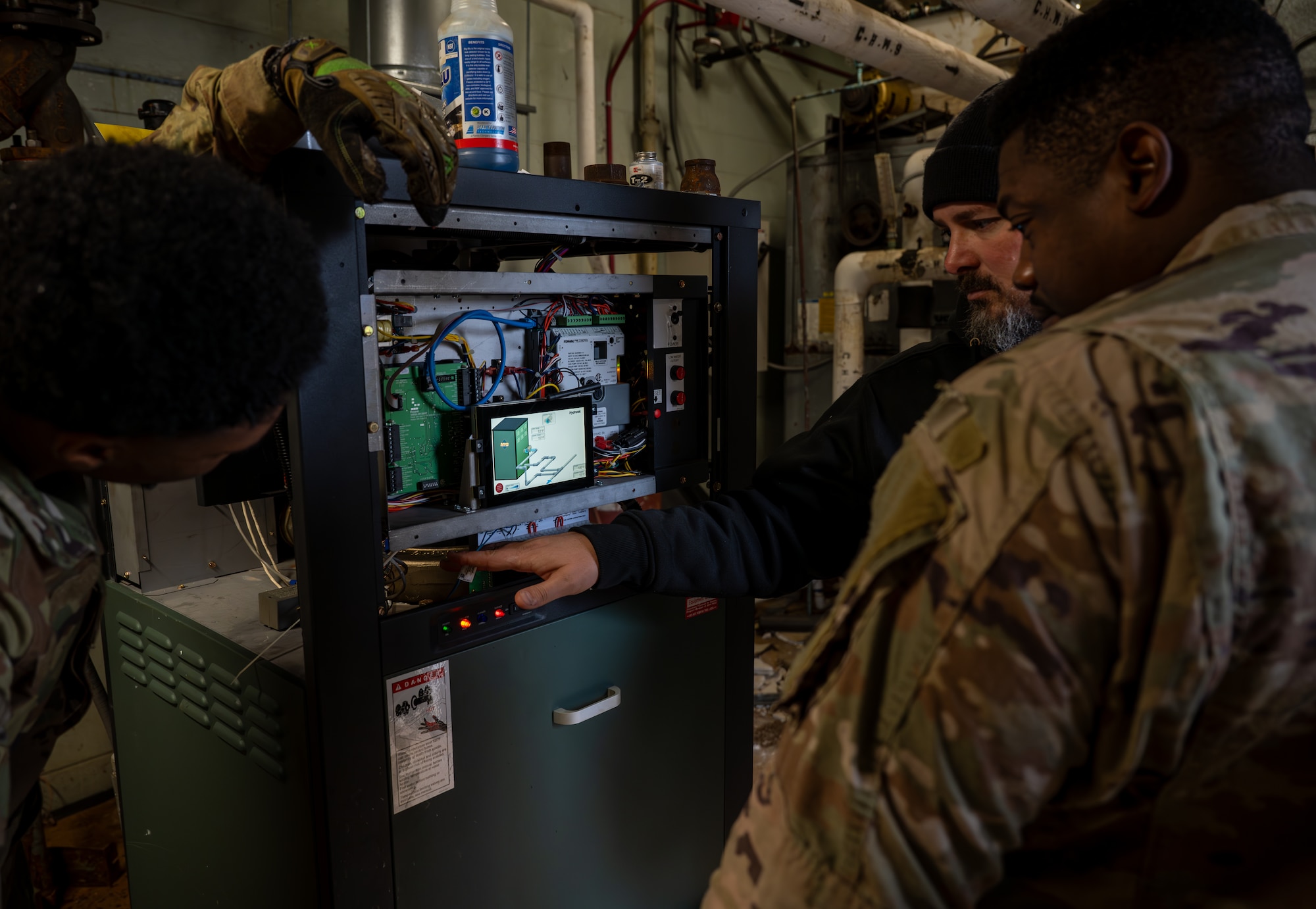 U.S. Air Force civil engineers assigned to the 1st Special Operations Wing change settings on a boiler control system at Hurlburt Field, Florida, Jan. 13, 2025.