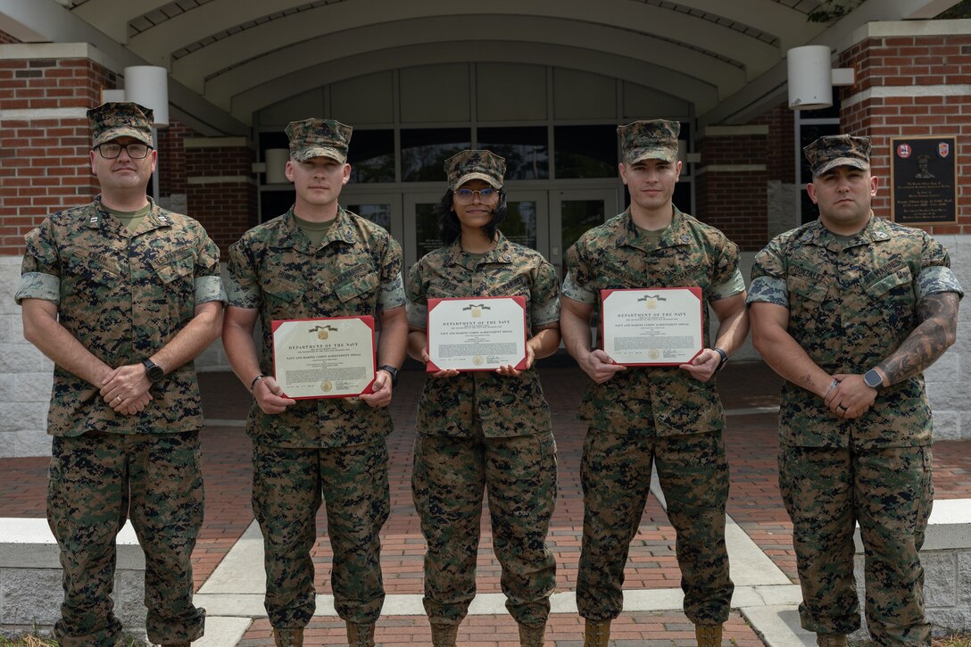 U.S. Marines with Distribution Management Instruction Company, Ground Supply School pose for a photo after an awards ceremony on Camp Gilbert H. Johnson, North Carolina, April 15, 2025. The Marines were awarded for developing a rotating schedule for the Distribution Specialist Basic Course that reduced Marines awaiting training time, ultimately reclaiming substantial manpower costs for the Marine Corps. (U.S. Marine Corps photo by Cpl. Zachariah Ferraro)
