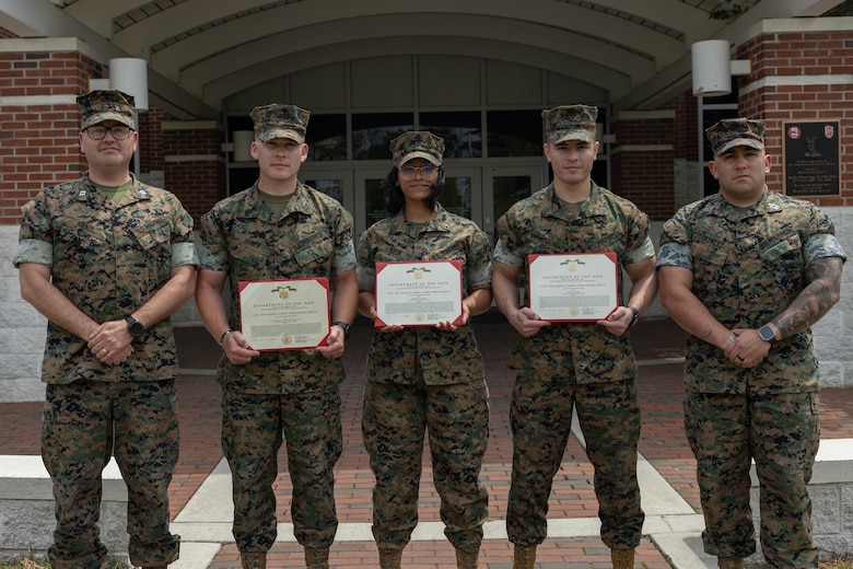 U.S. Marines with Distribution Management Instruction Company, Ground Supply School pose for a photo after an awards ceremony on Camp Gilbert H. Johnson, North Carolina, April 15, 2025. The Marines were awarded for developing a rotating schedule for the Distribution Specialist Basic Course that reduced Marines awaiting training time, ultimately reclaiming substantial manpower costs for the Marine Corps. (U.S. Marine Corps photo by Cpl. Zachariah Ferraro)