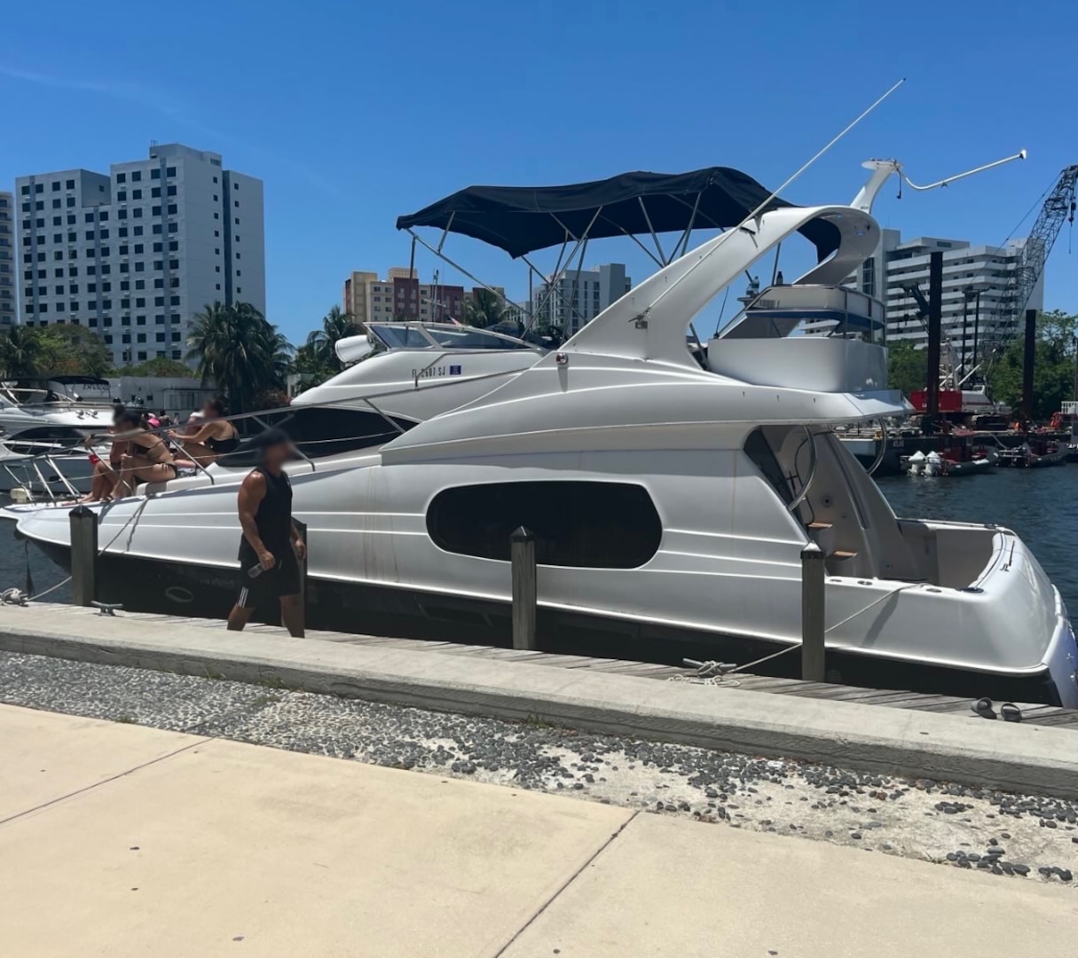 Coast Guard Sector Miami law enforcement officers, along with federal and state law enforcement partners, conduct a boarding on a 46-foot cabin cruiser, Isabella, in the vicinity of Lummus Park, Florida, May 18, 2025. The owner of Isabella was reportedly operating as an illegal small passenger vessel in violation of an active Captain of the Port order issued two days prior, for failing to properly execute a charter agreement. (U.S. Coast Guard photo)