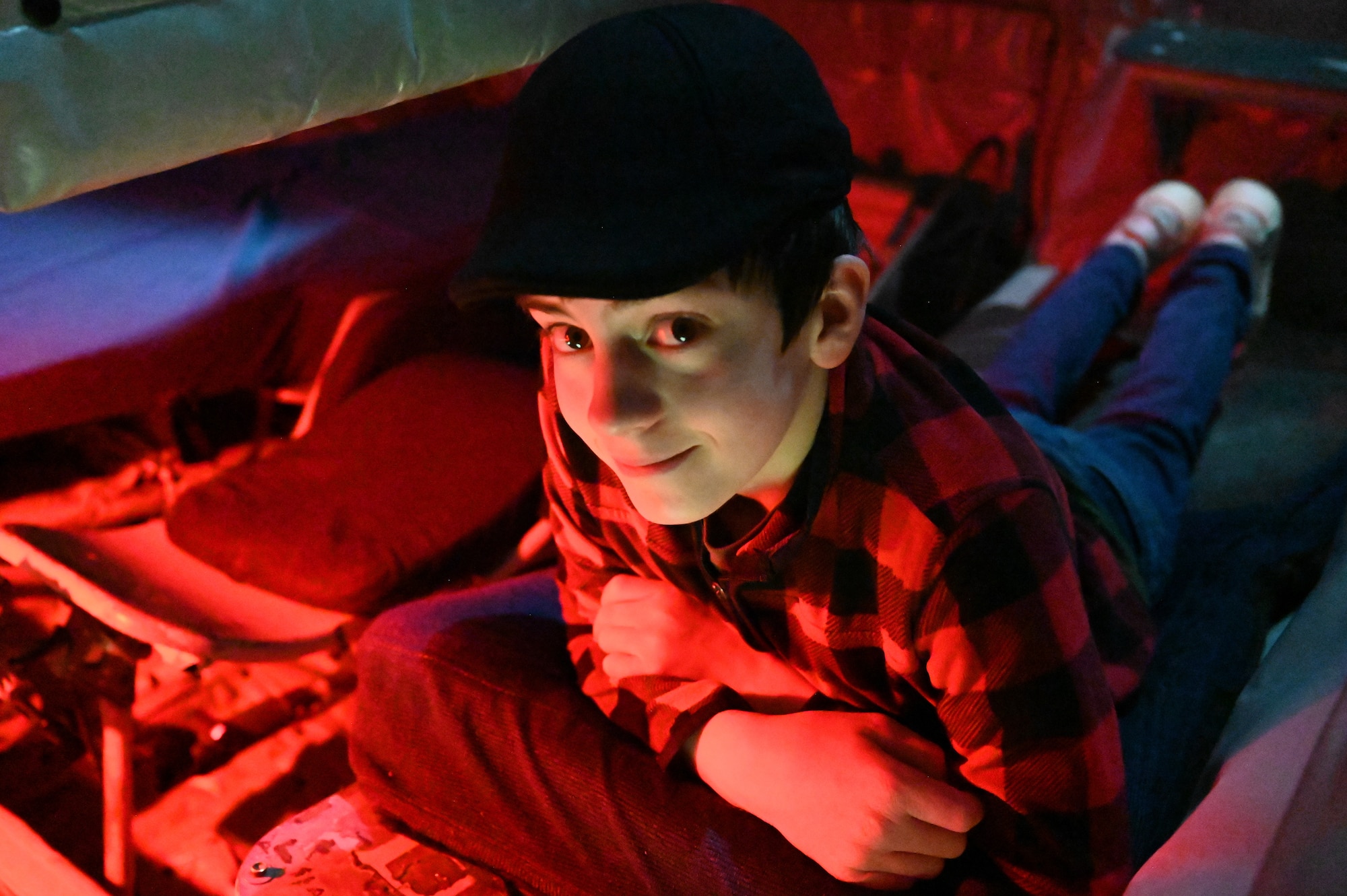 A young man sits in the boom operator's seat.