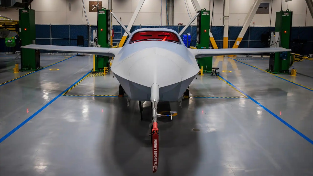 A small unmanned airplane sits inside a building.