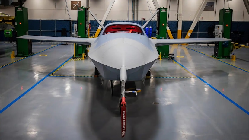 A small unmanned airplane sits inside a building.