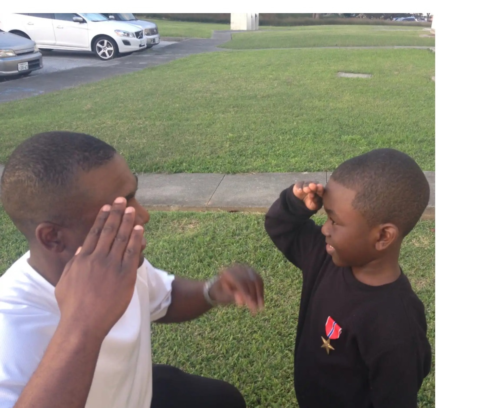 Senior Master Sgt. Wendell Snider presents Afghanistan deployment Bronze Star to his son after returning from deployment.