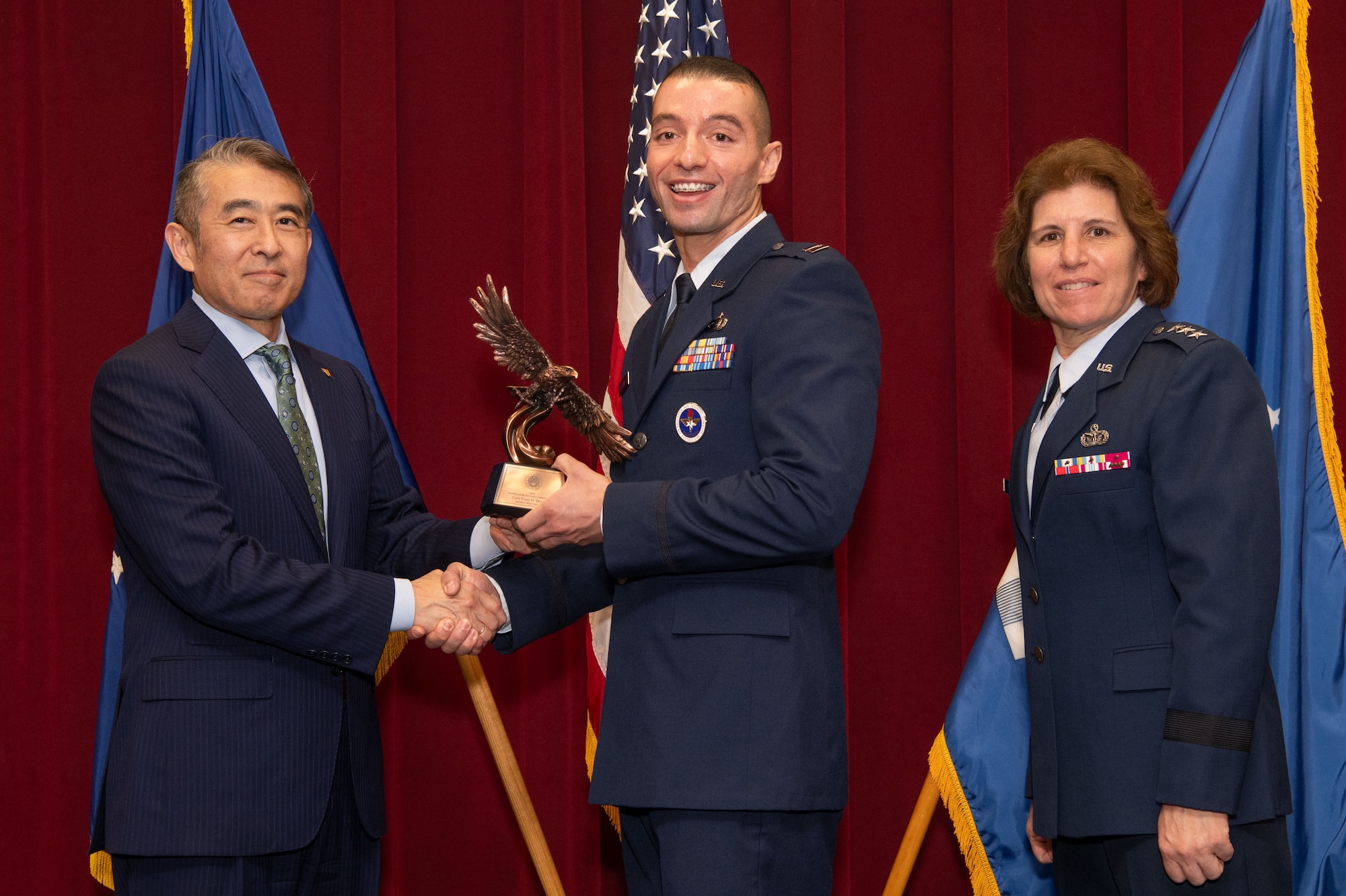 photo of Edwin Oshiba, Performing the Duties of Under Secretary of the Air Force, and Air University Commander and President Lt. Gen. Andrea Tullos present the 2025 Secretary of the Air Force Leadership award in the Company Grade Officer faculty category to Captain Esah Bouziane at Maxwell Air Force Base, Alabama, May 6, 2025