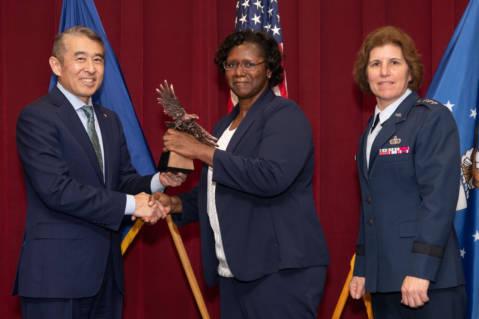 photo of Edwin Oshiba, Performing the Duties of Under Secretary of the Air Force, and Air University Commander and President Lt. Gen. Andrea Tullos present the 2025 Secretary of the Air Force Leadership award in the Civilian faculty category to Dr. Evelyn Watkins-Bean at Maxwell Air Force Base, Alabama, May 6, 2025.