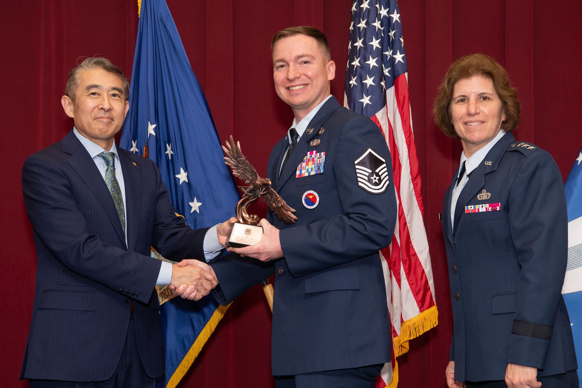 Photo of Edwin Oshiba, Performing the Duties of Under Secretary of the Air Force, and Air University Commander and President Lt. Gen. Andrea Tullos present the 2025 Secretary of the Air Force Leadership award in the Senior Non-Commissioned Officer faculty category to Master Sergeant Jacob M. Stubblefield at Maxwell Air Force Base, Alabama, May 6, 2025. Stubblefield distinguished himself as the A3 Senior Enlisted Leader at the Airey NCO Academy, Tyndall Air Force Base, Florida.