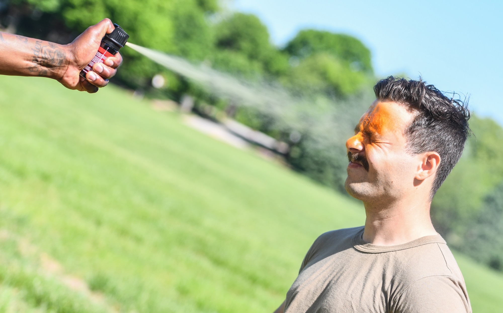 Airman 1st Class Kyle Wald, 55th Wing Chaplain Office, is sprayed with OC spray at Offutt Air Force Base, May 13.  The 55th SFS conducted OC spray displays as part of National Police Week festivities. (U.S. Air Force photo by Chad Watkins)