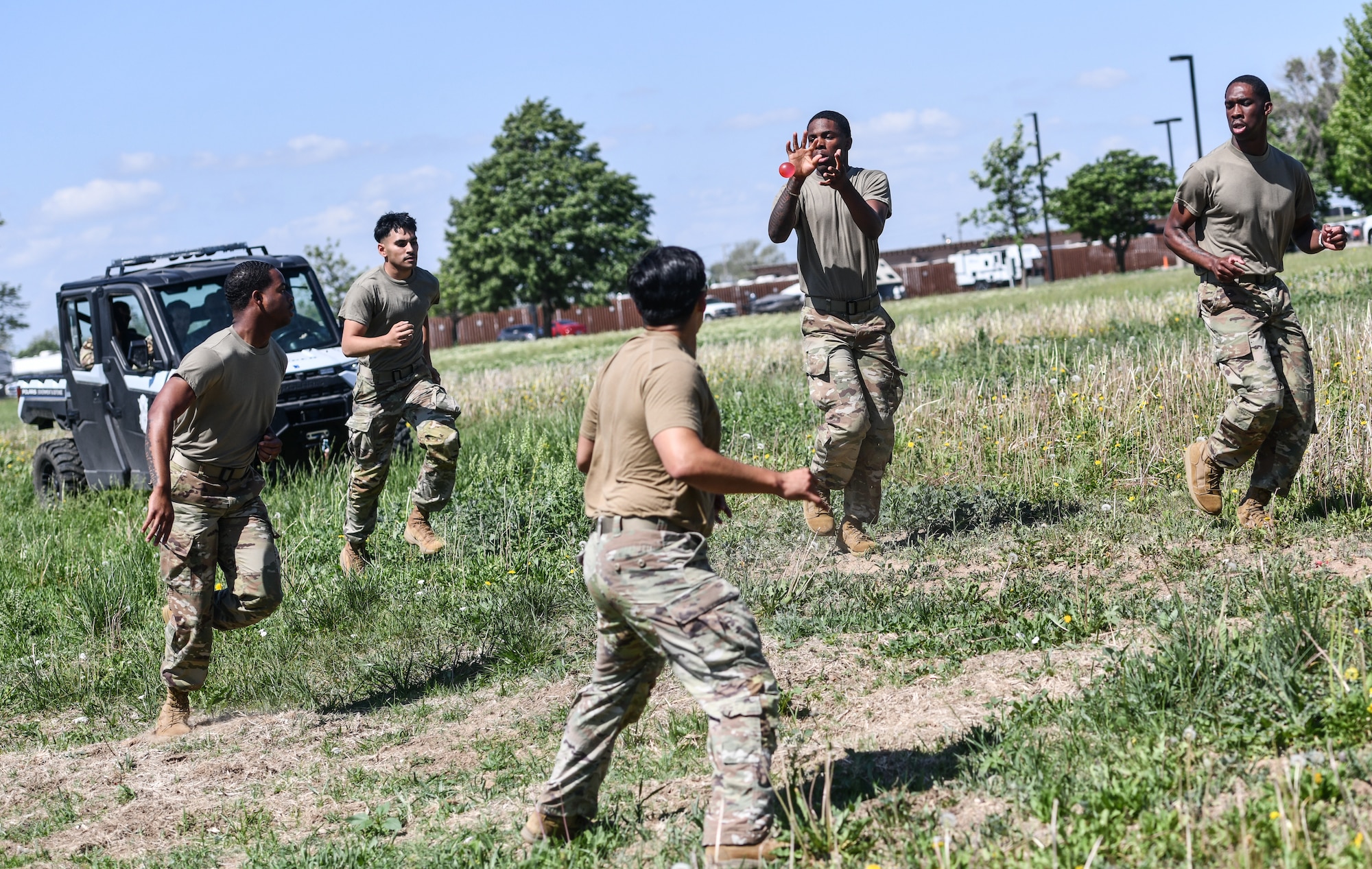 A 55th Security Forces team passes a water balloon during the Fire Team challenge during National Police Week festivities on Offutt Air Force Base, May 14. The Fire Team challenge was a four man event that featured an obstacle course, memory challenge, and endurance run. (U.S. Air Force photo by Chad Watkins)