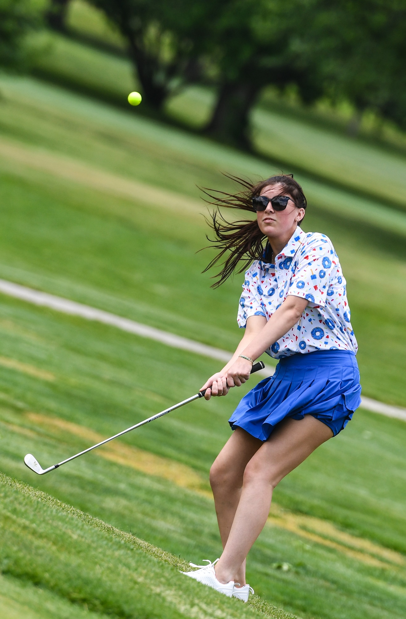Senior Airman Rylee Huskey, 55th Security Forces Squadron, chips on to the green during National Police Week festivities on Offutt Air Force Base, May 14. SFS held a golf tournament to round out the week's festivities. (U.S. Air Force photo by Chad Watkins)