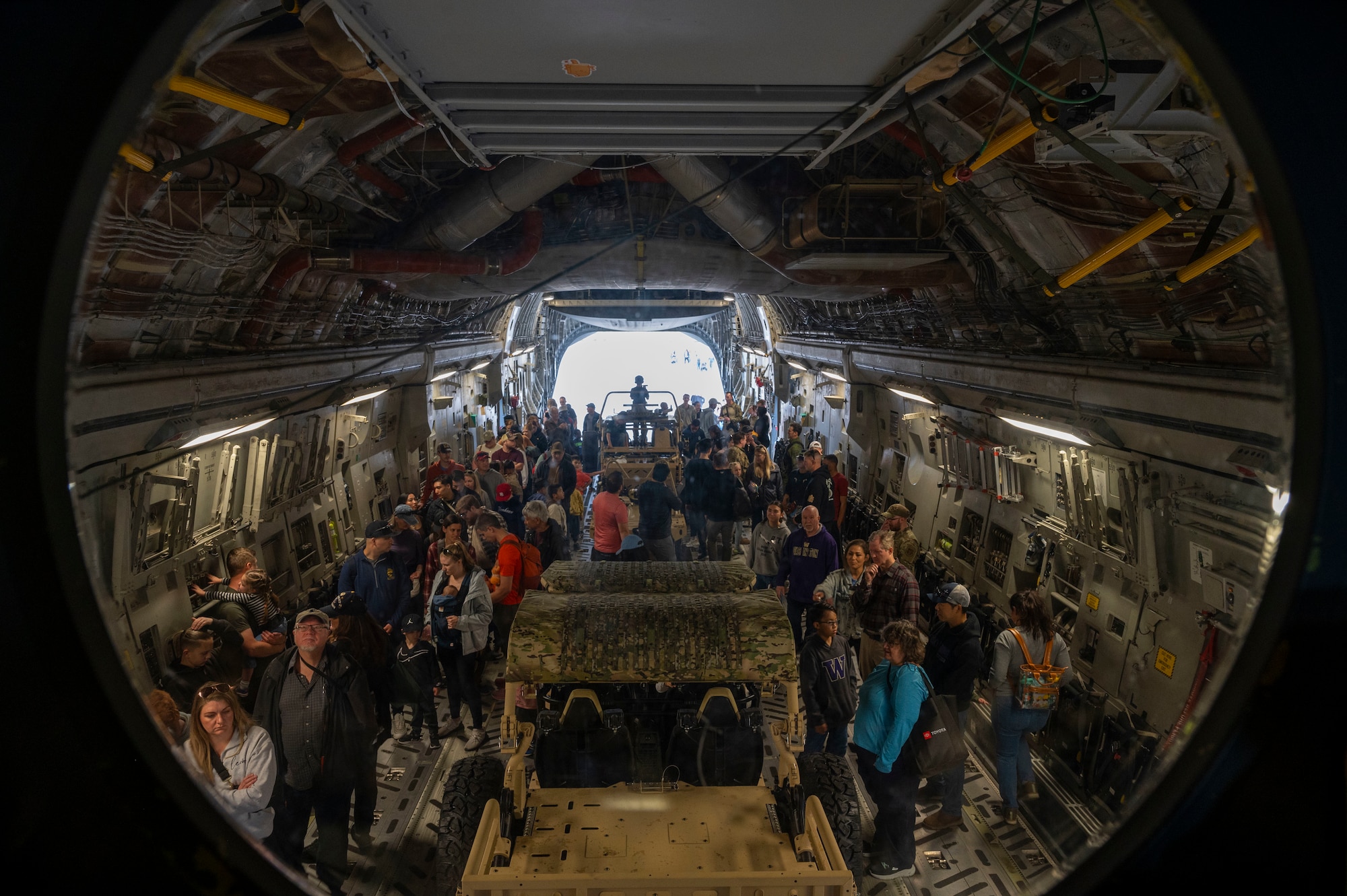 A line of attendees wait their turn to tour a Globemaster III cockpit during Armed Forces Day at Joint Base Lewis-McChord, Washington, May 17, 2025.
