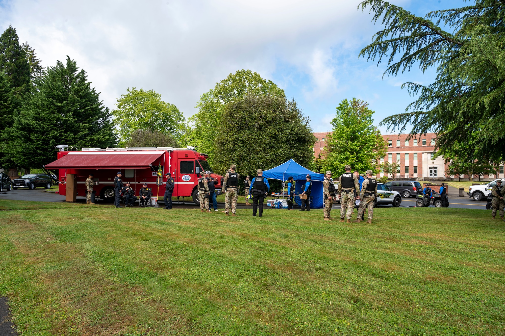 U.S. Army and U.S. Air Force security forces personnel stand ready at emergency aid tents and vehicles during Armed Forces Day at Joint Base Lewis-McChord, Washington, May 17, 2025.