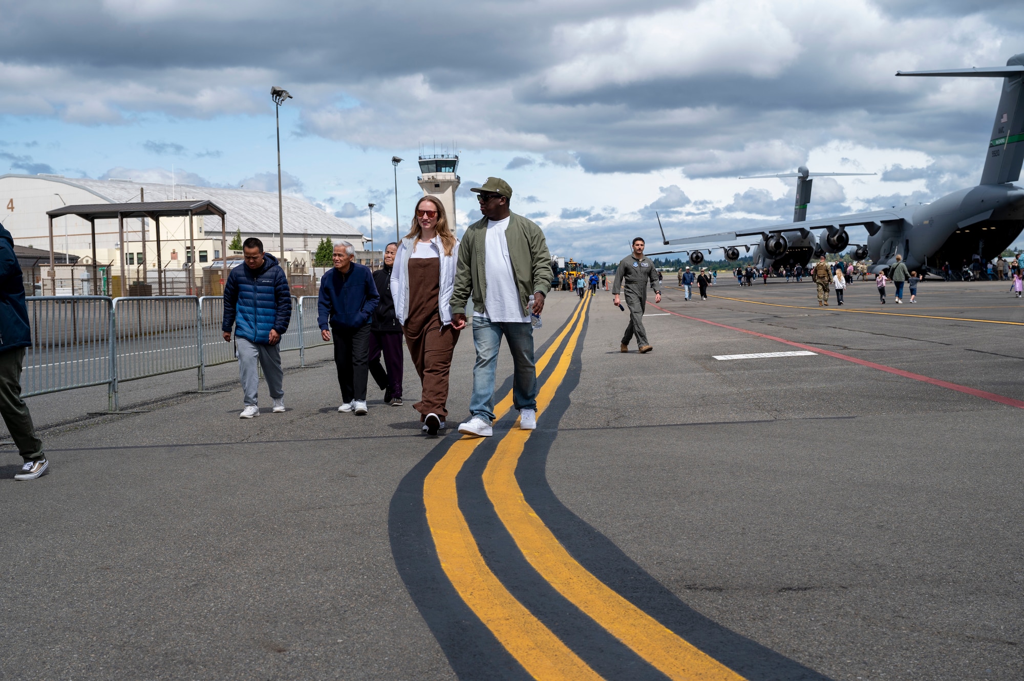 Attendees at the Armed Forces Day event walk on the flightline at Joint Base Lewis-McChord, Washington, May 17, 2025.