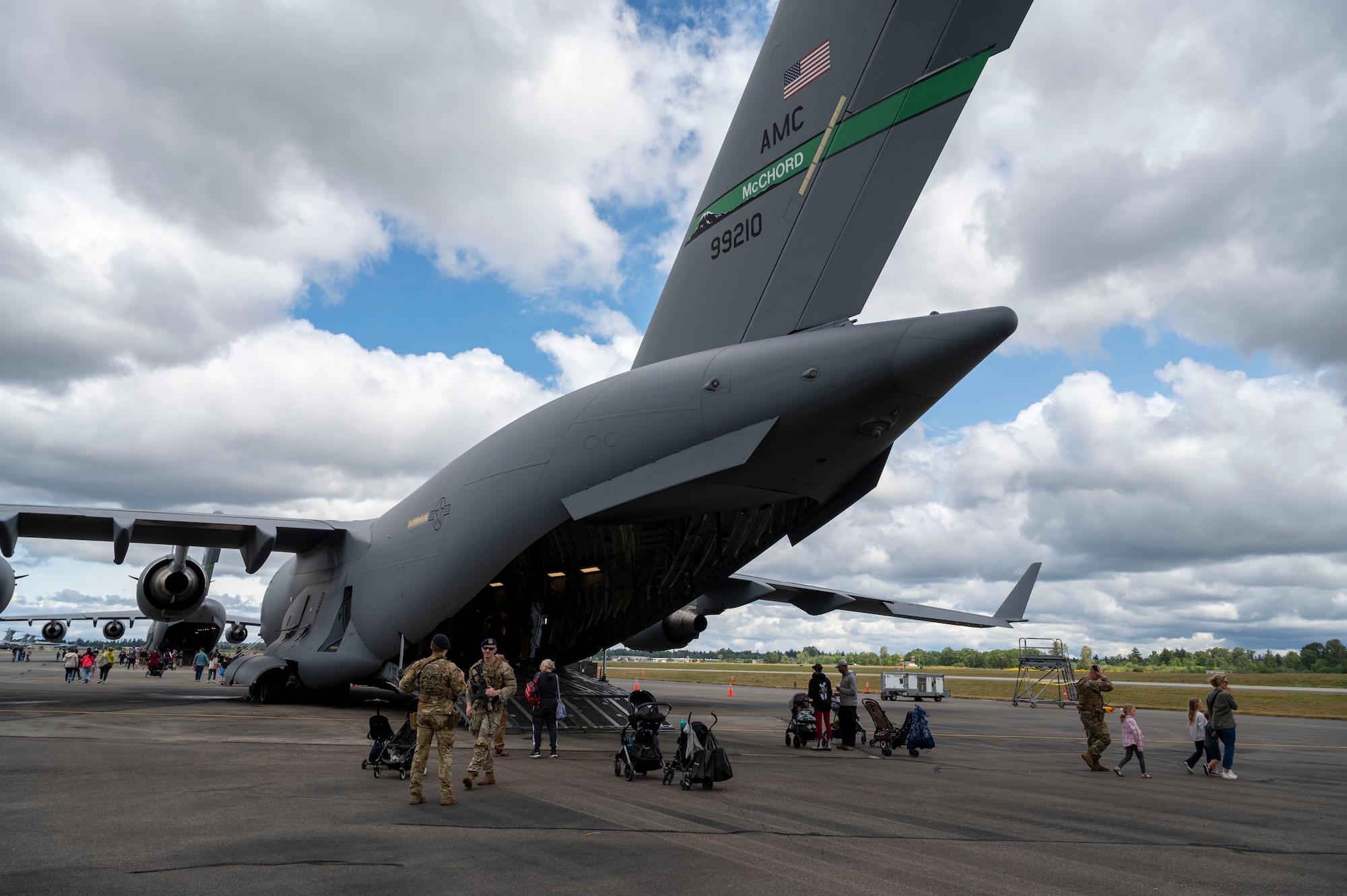 Attendees at Armed Forces Day enter and exit a C-17 Globemaster III at Joint Base Lewis-McChord, Washington, May 17, 2025.