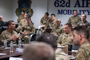 U.S. Air Force Gen. John Lamontagne, Air Mobility Command commander, center-right, Col. Sergio Anaya, 62d Airlift Wing commander, left, and other Team McChord leadership attend a briefing at Joint Base Lewis-McChord, Washington, May 19, 2025.