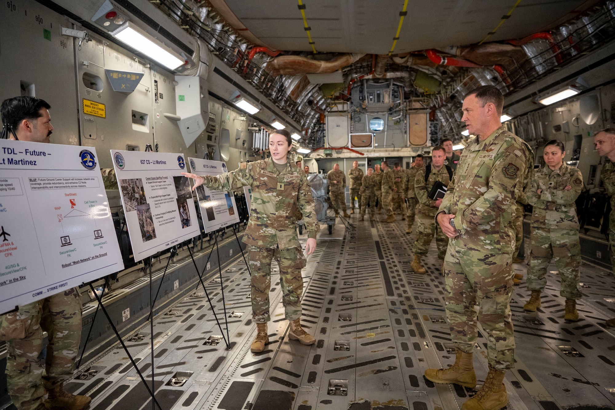 U.S. Air Force Gen. John Lamontagne, Air Mobility Command commander, listens to 1st Lt. Nalin Martinez, 627th Communications Squadron Operations Flight officer-in-charge, at Joint Base Lewis-McChord, Washington, May 19, 2025.