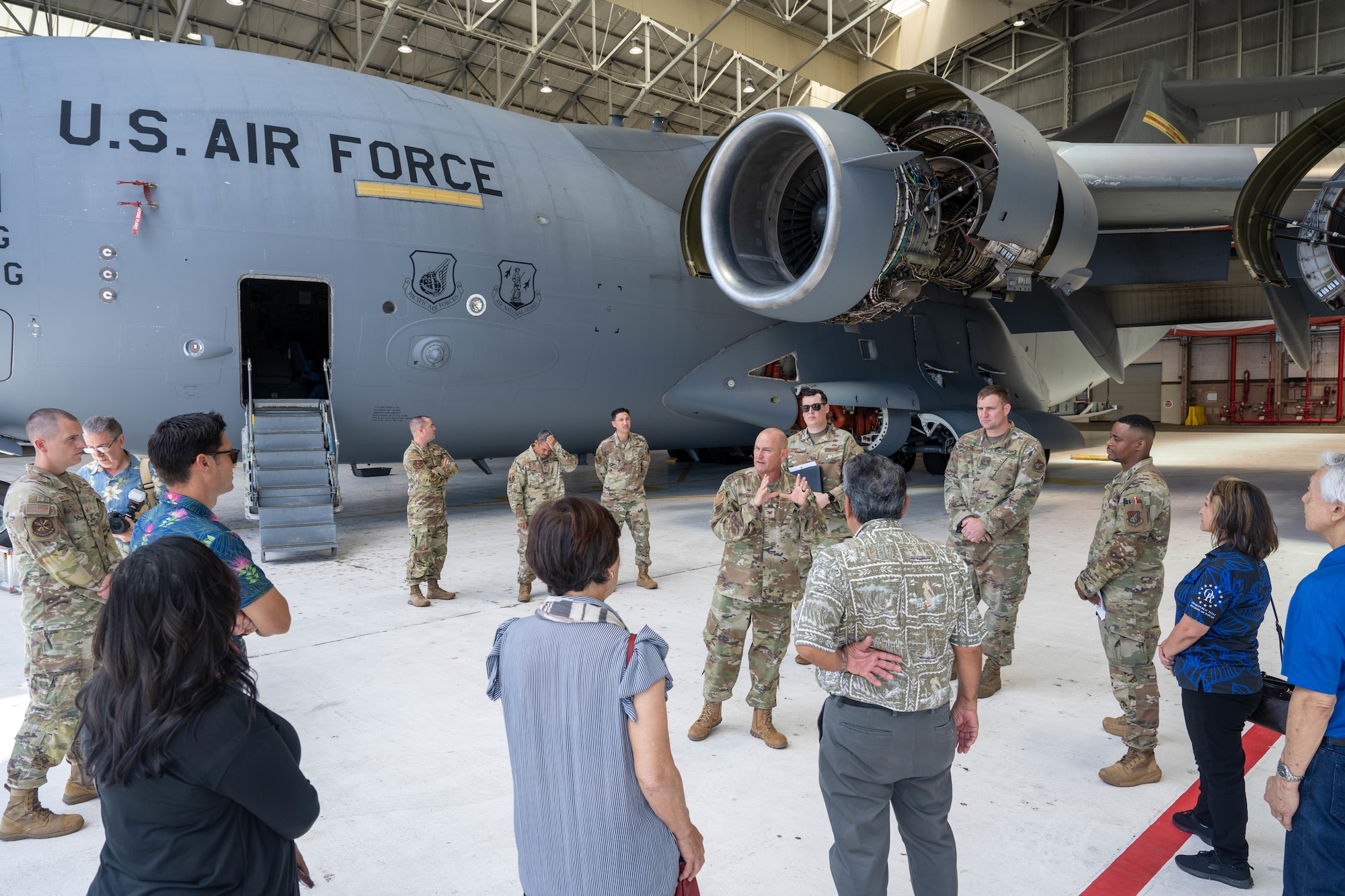 U.S. Air Force Airmen talk to civilians about the capabilities of a C-17 Globemaster III.