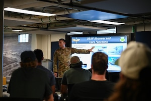 Global College of PME course director briefs local sports team