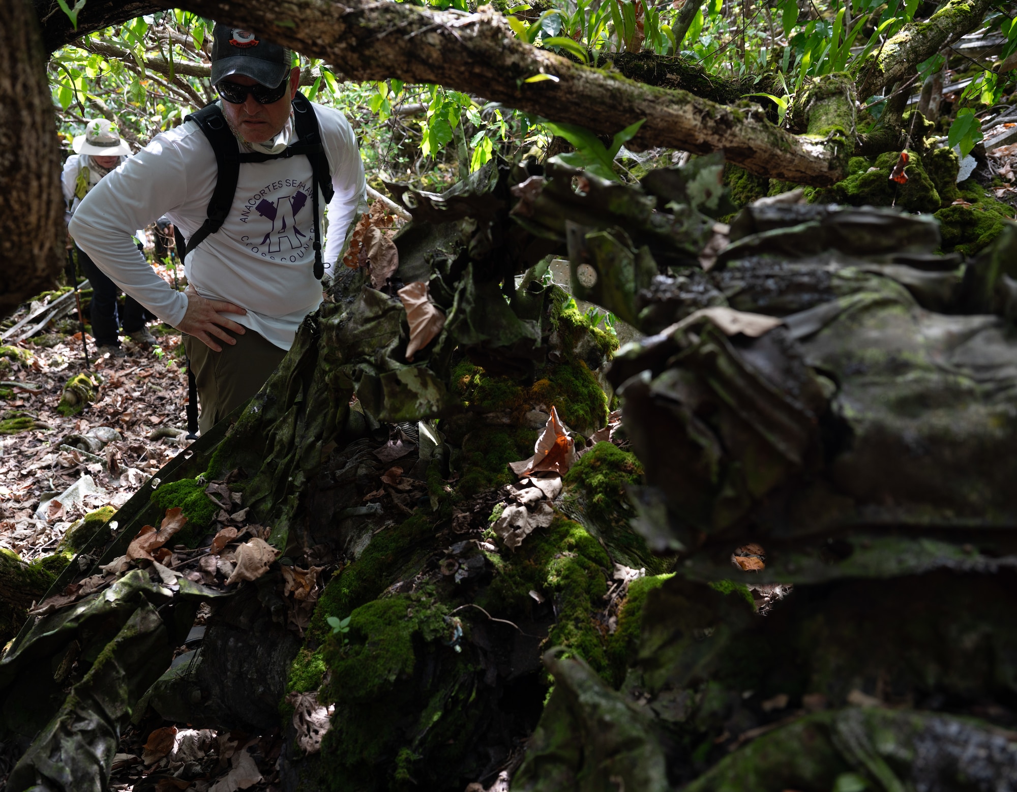 J.T. Pianetta, great nephew of Capt. Carl Bauer, inspects the wreckage at the B-29 "Colleen" crash site on Andersen Air Force Base, Guam, April 11, 2025. J.T.'s mother, Liz Pianetta, is the niece of Capt. Bauer. Bauer flew B-29 "Colleen" for 13 successful bombing missions, before tragedy occurred on the 14th. A mixture of mechanical issues and bad weather forced the plane and its crew to their final resting place into the northern cliffside jungles of Guam. 2025 marks the 80th Anniversary of the accident and J.T. and his family came to the site to honor the fallen. (U.S. Air Force photo by Staff Sgt. Pedro Tenorio)
