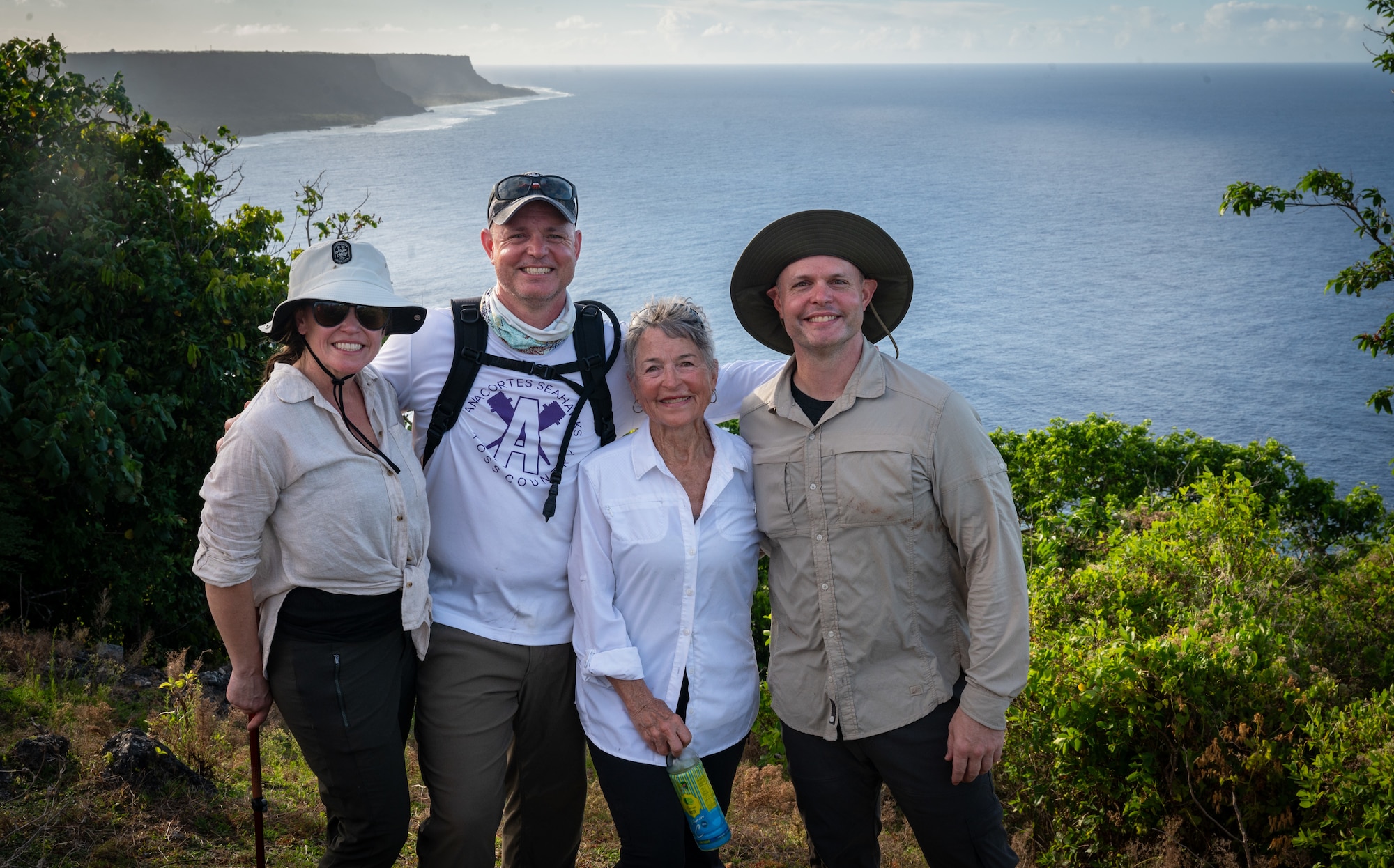 From left, Caitlin, J.T., Liz, and Matt Pianetta pose for a photo at Tarague Overlook on Andersen Air Force Base, Guam, April 11, 2025. The family came to Guam to visit the B-29 "Colleen" crash site located in the jungles below the overlook. This crash site would be where Capt. Carl Bauer, Liz's uncle, perished in a tragedy involving engine troubles and bad weather. 2025 marks the 80th anniversary of the accident, Liz decided it was her turn to make the journey, following in the footsteps of other family members who have visited in past years. (U.S. Air Force photo by Staff Sgt. Pedro Tenorio)