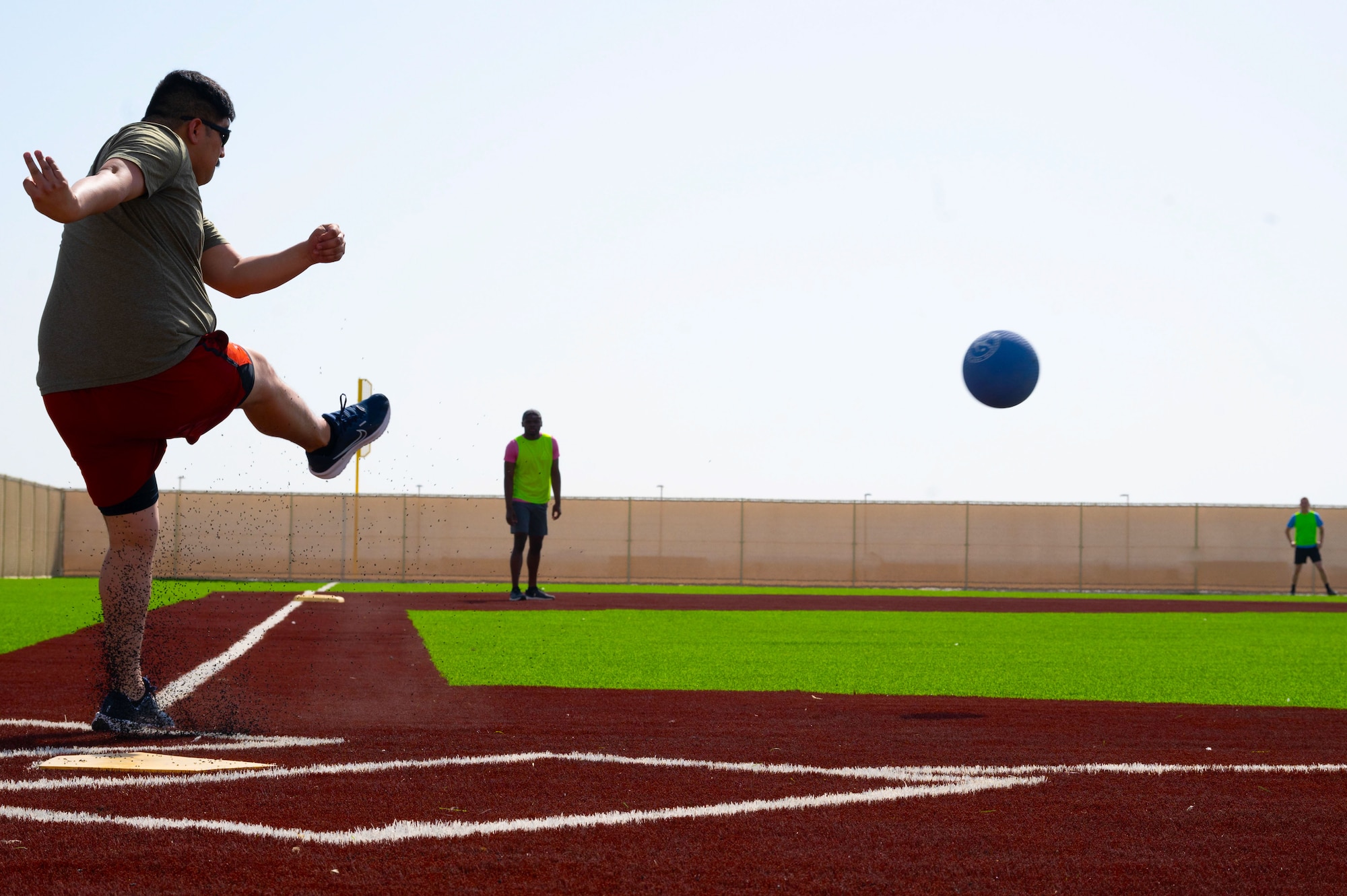 A U.S. Airman kicks a ball during Sports Day within the U.S. Central Command area of responsibility, May 16, 2025. Kickball was one of several events held during the 379th Air Expeditionary Wing Sports Day celebration, in addition to volleyball, pickleball and dodgeball games. (U.S. Air Force Photo by Senior Airman Dieondiere Jefferies)