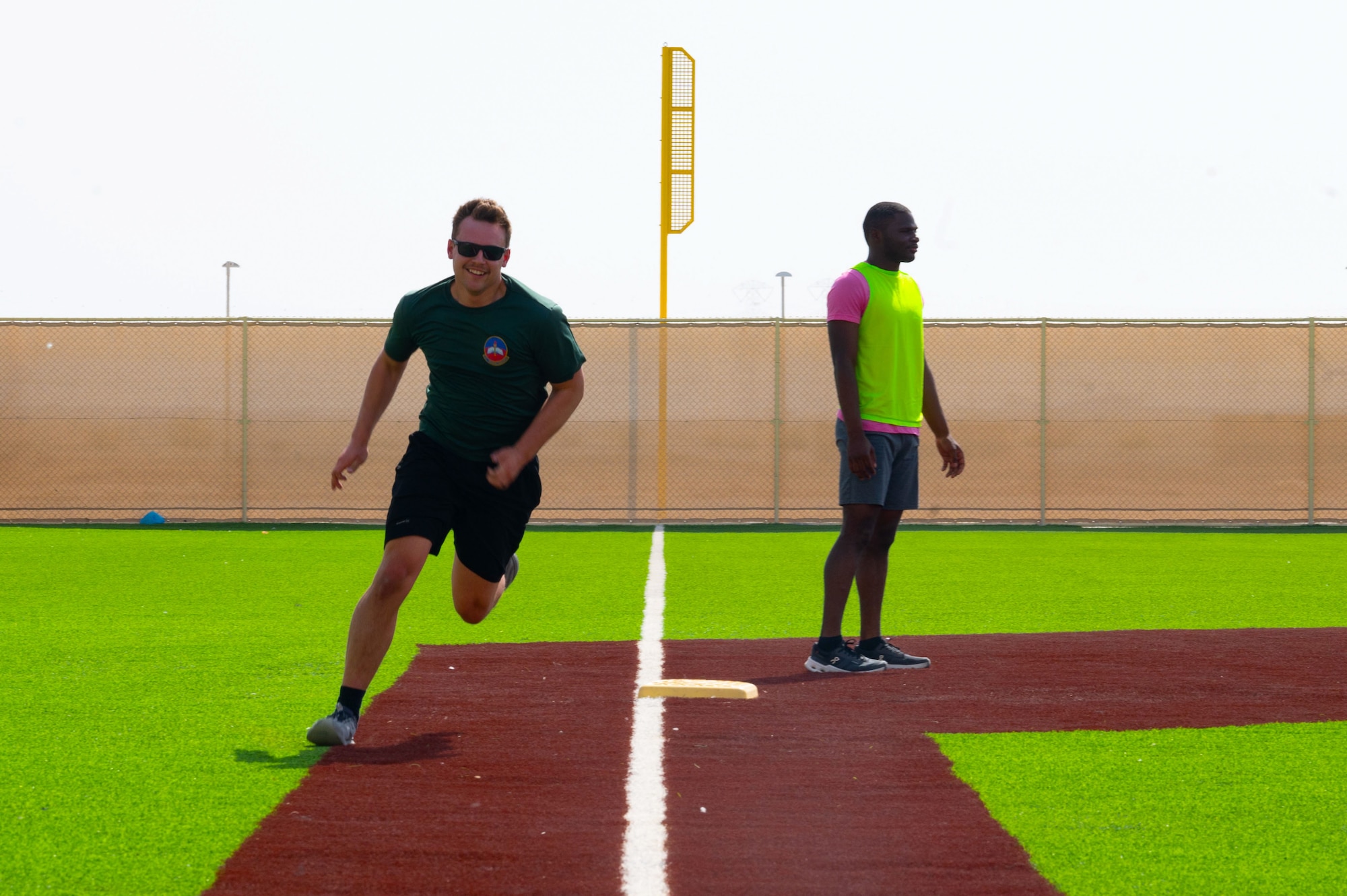 A U.S. Airman runs past third base during a game of kickball within the U.S. Central Command area of responsibility, May 16, 2025. Kickball was one of several events held during the 379th Air Expeditionary Wing Sports Day celebration, in addition to volleyball, pickleball and dodgeball games. (U.S. Air Force Photo by Senior Airman Dieondiere Jefferies