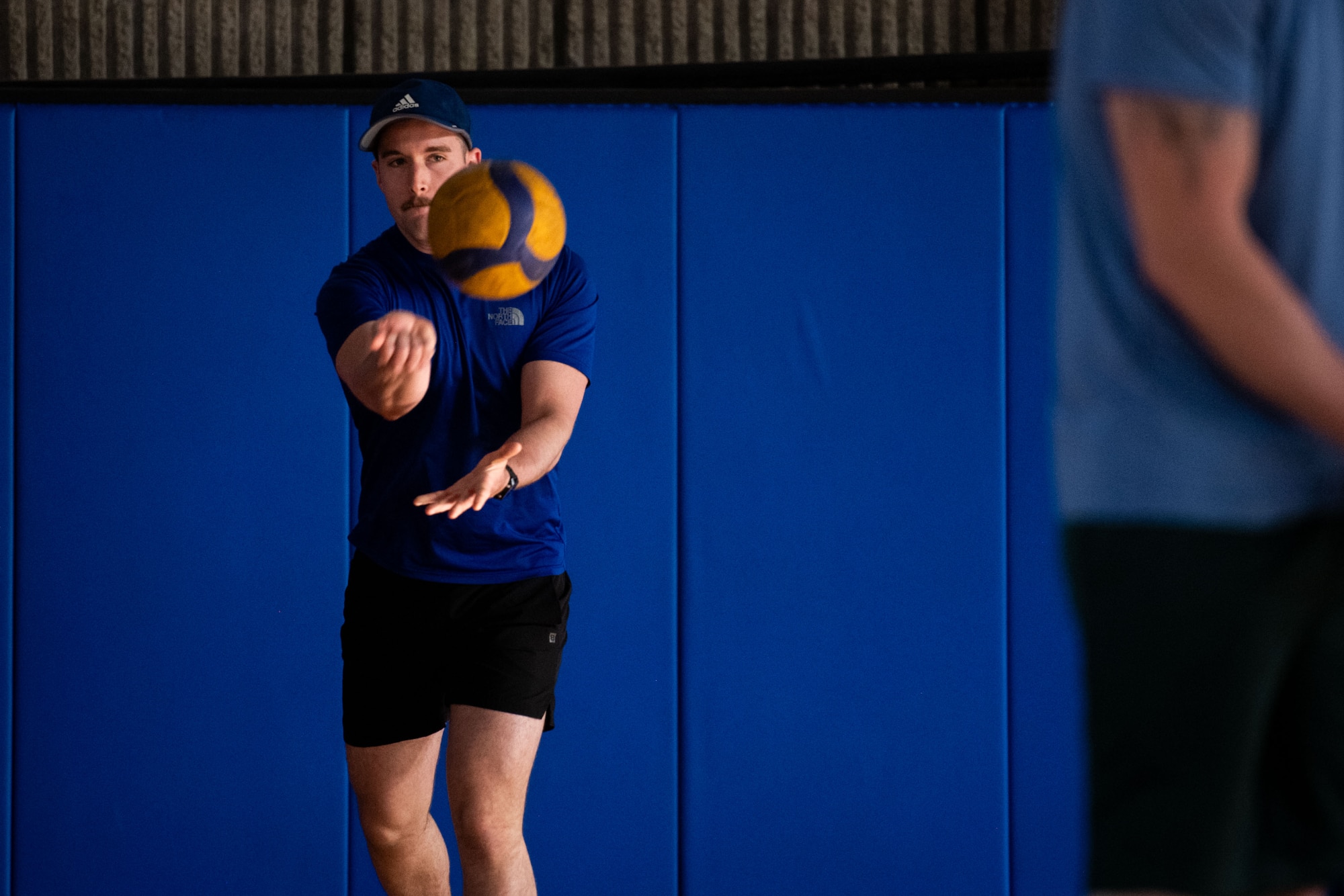 A U.S. Airman serves during a game of volleyball within the U.S. Central Command area of responsibility, May 16, 2025. Volleyball was one of several events held during the 379th Air Expeditionary Wing Sports Day celebration, in addition to kickball, pickleball and dodgeball games. (U.S. Air Force Photo by Staff Sgt. Sean Moriarty)