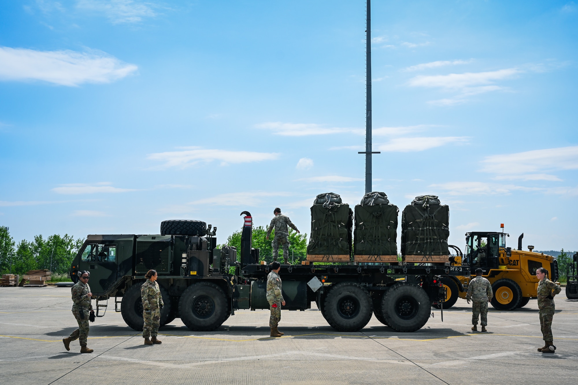 U.S. Air Force Airmen assigned to the 726th Air Mobility Squadron, 73rd Aerial Port Squadron, and U.S. Army soldiers from the 173rd Airborne Brigade unload cargo during Swift Response 25 at Spangdahlem Air Base (AB), Germany, May 15, 2025.