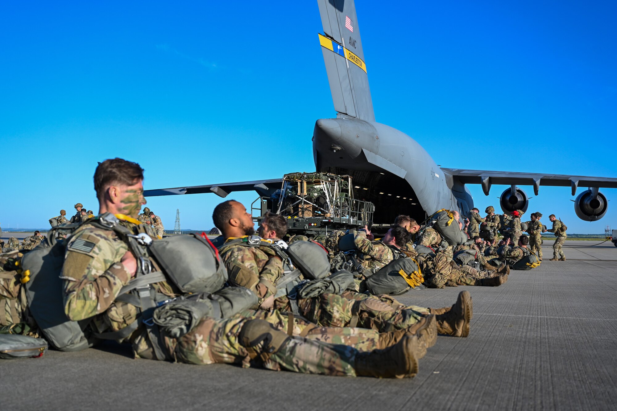 A 726th Air Mobility Squadron 25k loader prepares to load an infantry squad vehicle onto a C-17 Globemaster III during Swift Response 25 at Spangdahlem Air Base, Germany, May 16, 2025.