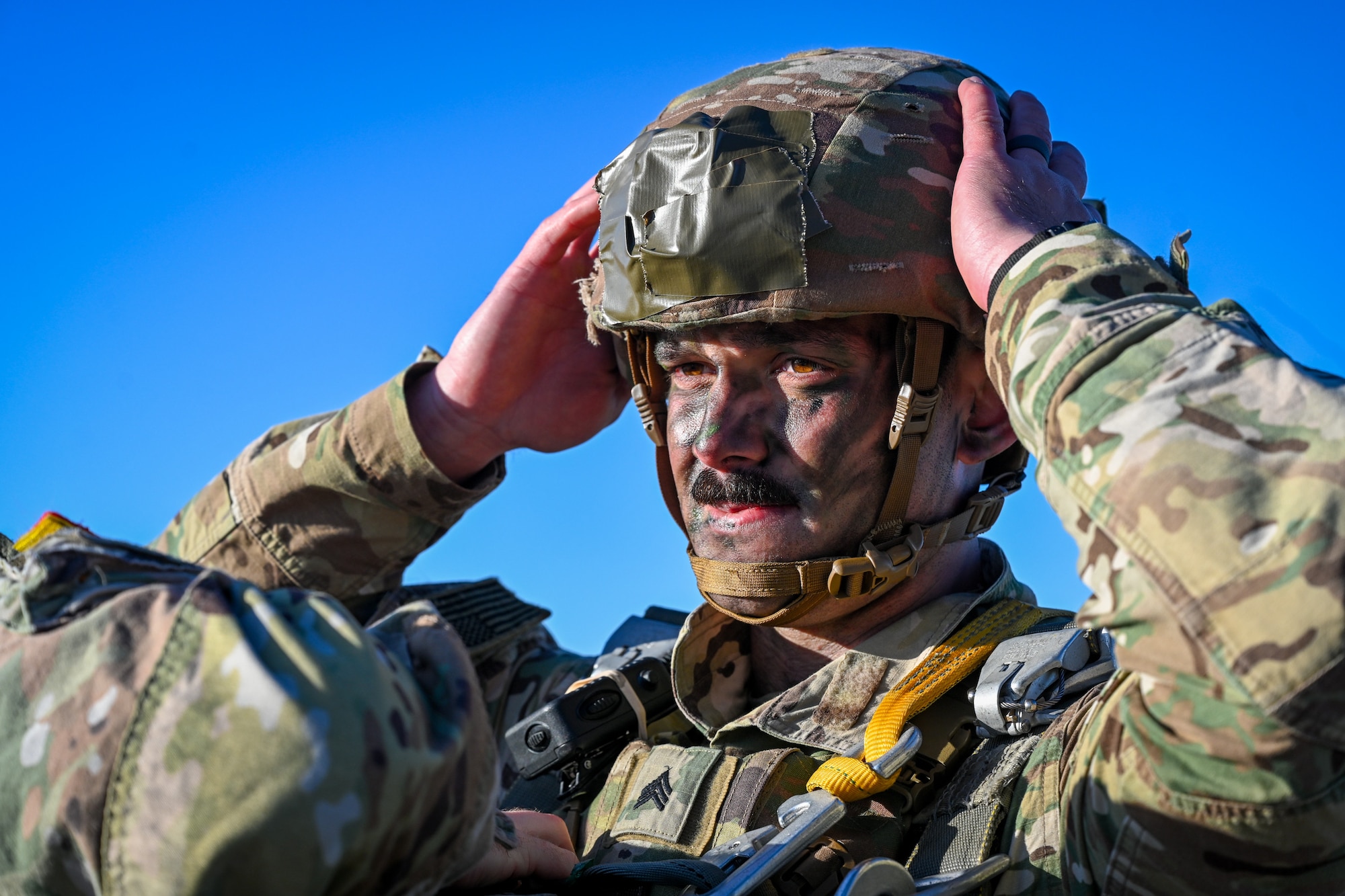 A U.S. Army paratrooper from the 173rd Airborne Brigade has a battle buddy check his parachute rig before boarding a C-17 Globemaster III during Swift Response 25 on the flightline at Spangdahlem Air Base, Germany, May 16, 2025.