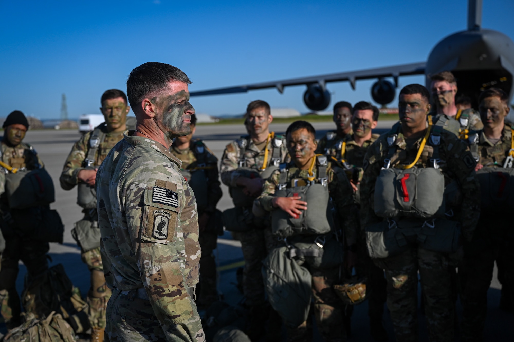 U.S. Army Col. Joshua Gaspard, 173rd Airborne Brigade commander, addresses his troops prior to boarding a C-17 Globemaster III for a jump during Swift Response 25 on the flightline at Spangdahlem Air Base, Germany, May 16, 2025.