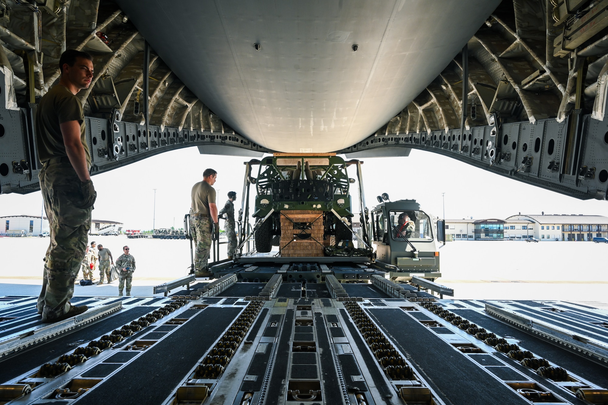 U.S. Air Force Airmen load an U.S. Army Infantry Support Vehicle onto a C-17 Globemaster III during Swift Response 25 on the flightline at Spangdahlem Air Base, Germany, May 15, 2025.