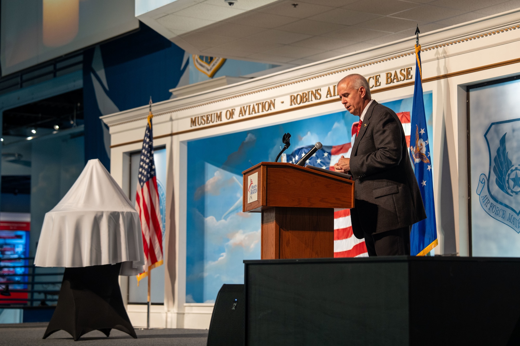 Man on stage speaking behind a podium