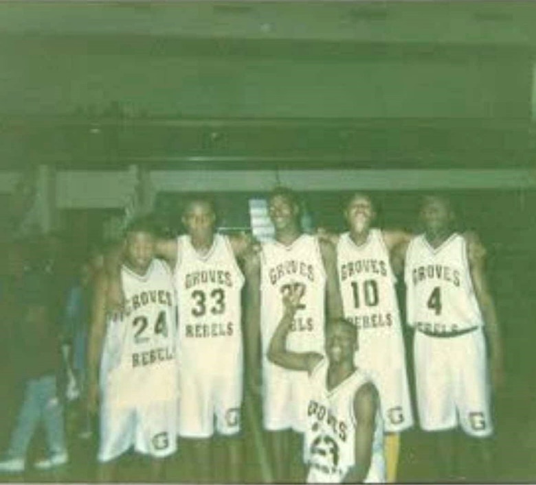 Photo of Tyrone Chisholm with members of his basketball team.