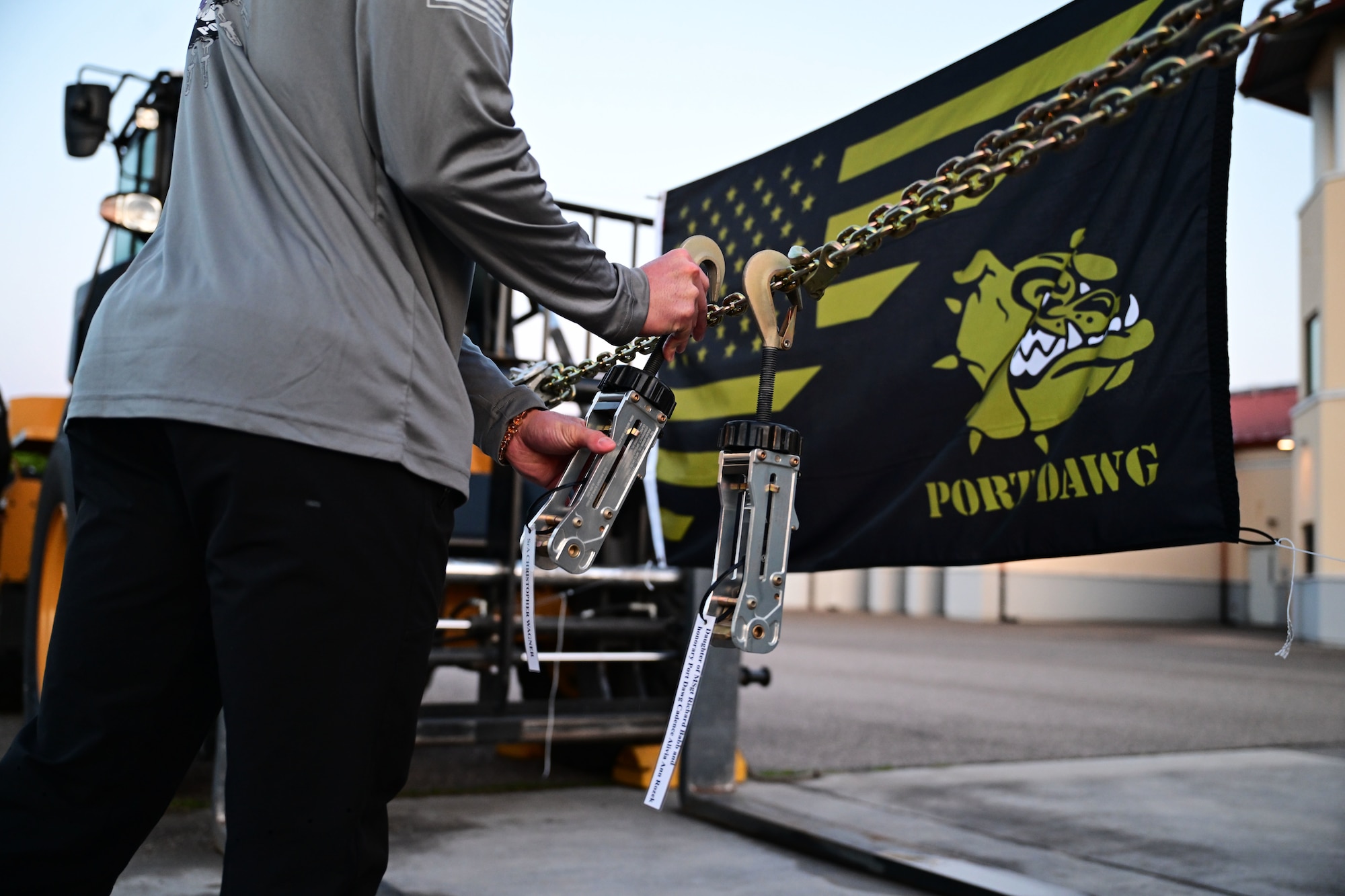 a member takes an MB-1 device hanging up displaying names of fallen port dawgs.