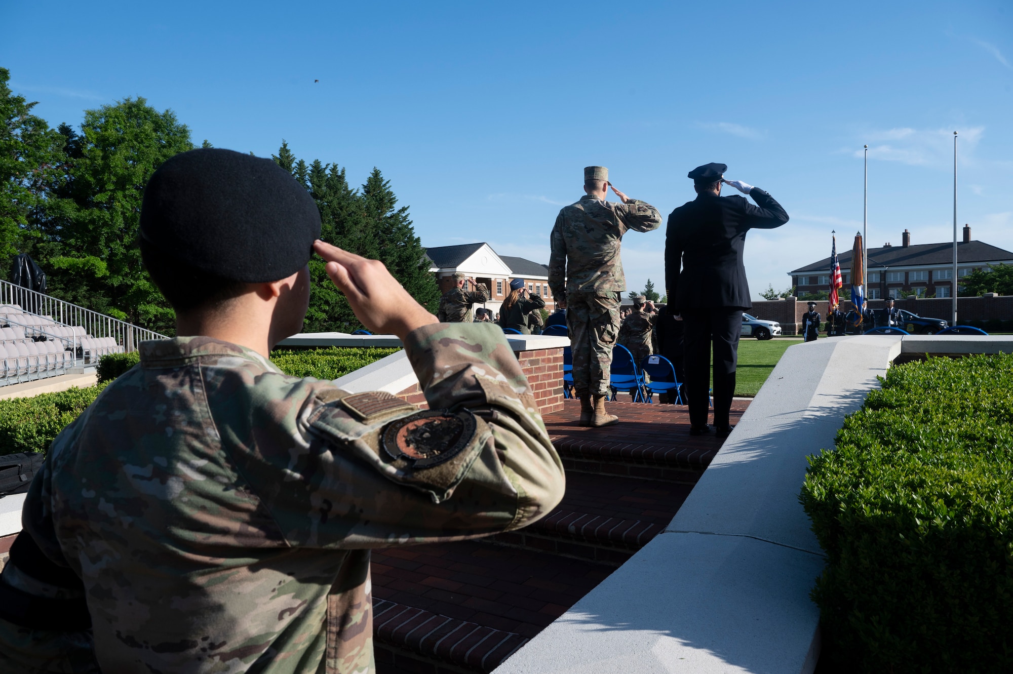 From left, U.S. Air Force Airman 1st Class Daniel Garcia, a patrolman assigned to the 11th Security Forces Squadron, U.S. Air Force Col. Ryan A. F. Crowley, commander of JBAB and the 11th Wing, and D.C. Metropolitan Police Department Chief of Police Pamela A. Smith, render a salute during the playing of “The Star-Spangled Banner” prior to the opening ceremony of National Police Week on Joint Base Anacostia-Bolling, Washington, D.C., May 12, 2025. Crowley and Smith delivered remarks highlighting the teamwork and dedication of law enforcement from JBAB and MPD. (U.S. Air Force photo by Hayden Hallman)