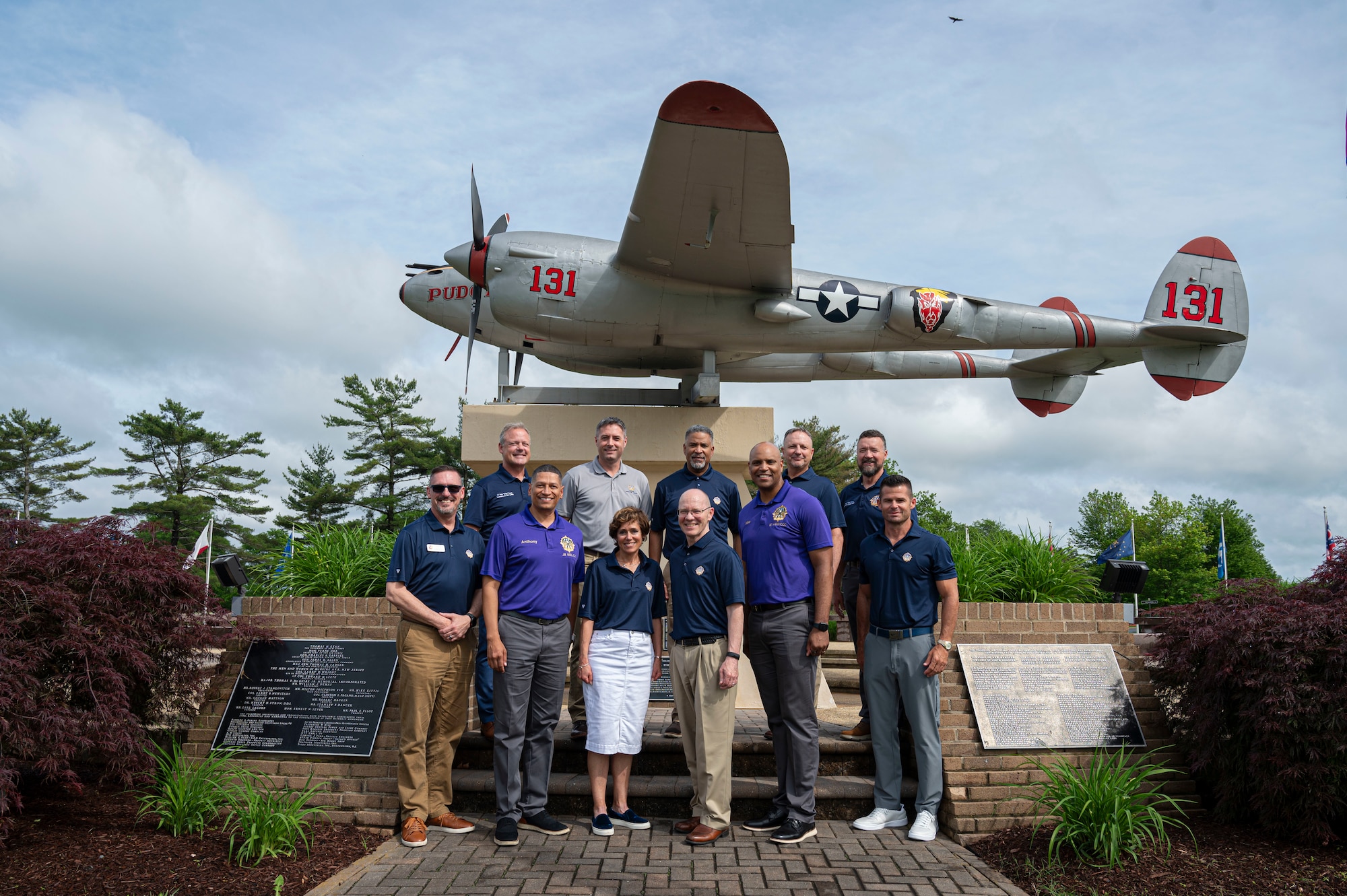 U.S. Air Force Col. Anthony Smith, Joint Base McGuire-Dix-Lakehurst and 87th Air Base Wing commander, and U.S. Air Force Chief Master Sgt. Michael Wynne, 87th ABW command chief, pose for a photo with prior leaders during the inaugural 2025 Prior Leaders Summit.