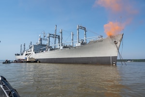 A smoking ship sails on the river. (U.S. Air Force photo by Airman 1st Class Donnell Ramsey)
