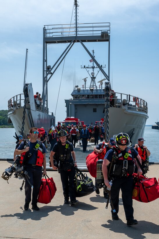 Firefighters walk to shore from ship. (U.S. Air Force photo by Airman 1st Class Donnell Ramsey)