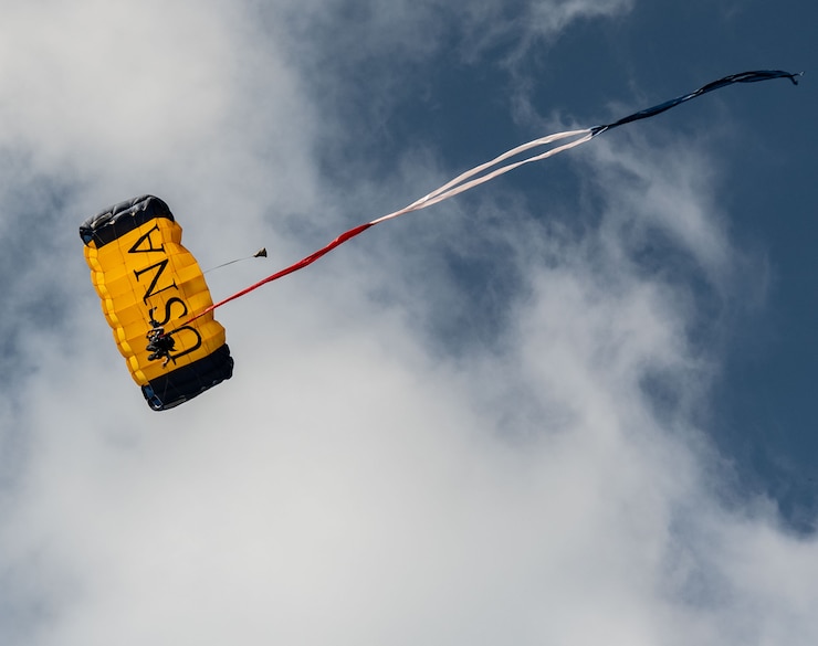 U.S. Naval Academy Parachute Team members land on Worden Field prior to the Brigade of Midshipmen’s second formal parade