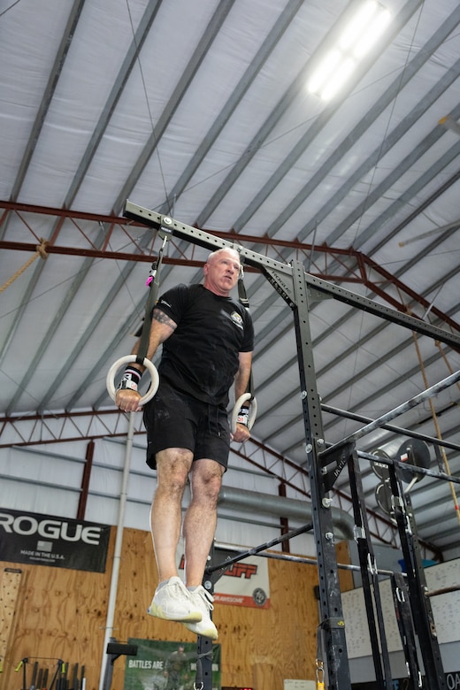 U.S. Army Col. Eddie Simpson performs ring lifts.