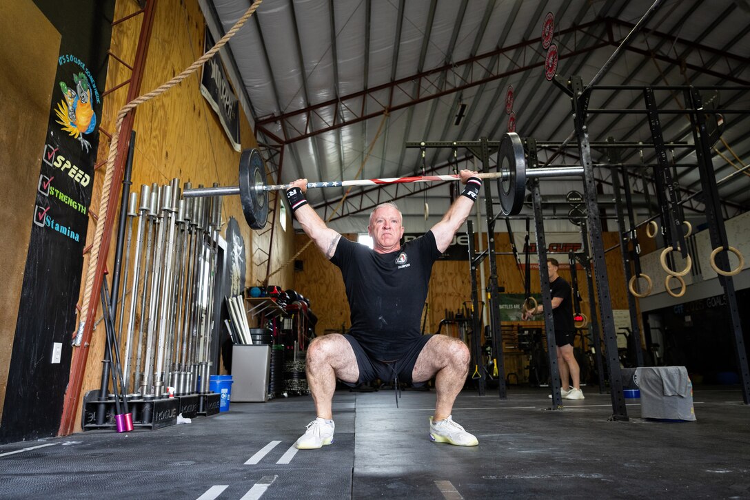 U.S. Army Col. Eddie Simpson performs snatches at CrossFit Frankfort in Frankfort, Ky. on May 15, 2025.
