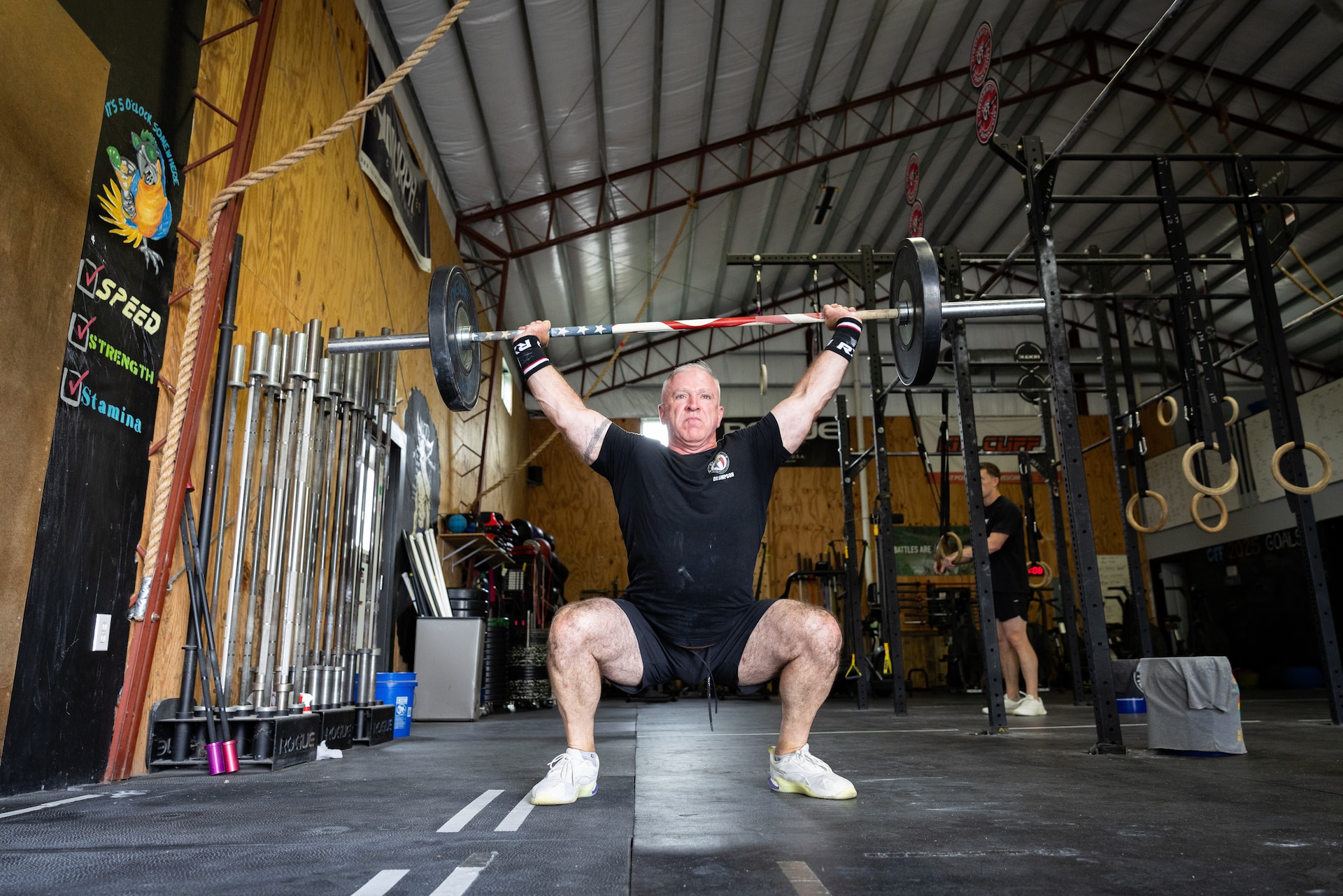 U.S. Army Col. Eddie Simpson performs snatches at CrossFit Frankfort in Frankfort, Ky. on May 15, 2025.