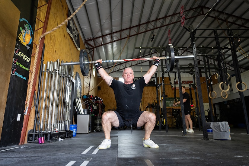 U.S. Army Col. Eddie Simpson performs snatches at CrossFit Frankfort in Frankfort, Ky. on May 15, 2025.