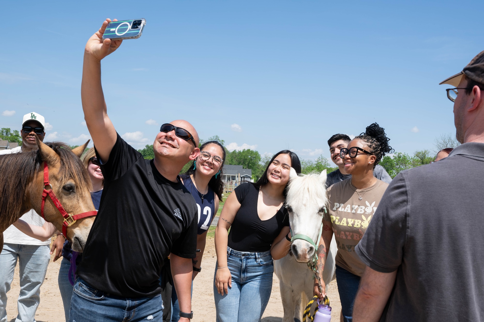 Members of AFMAO pose for selfie with a horse during a resilience event.