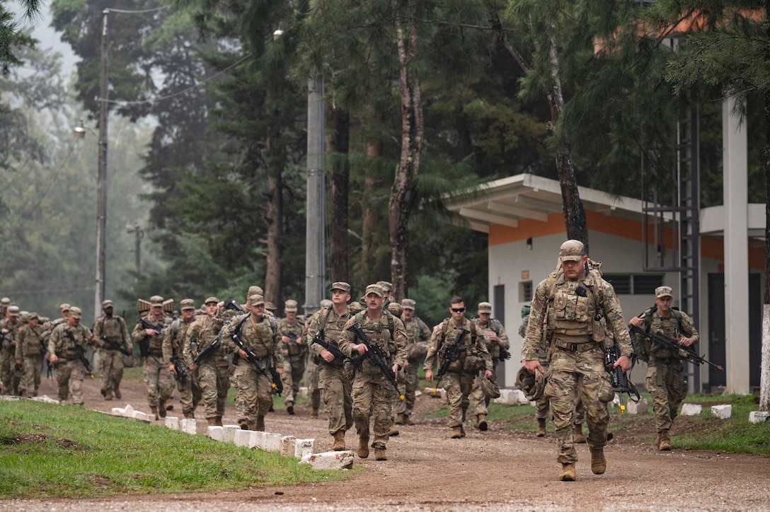 U.S. service members march along a road